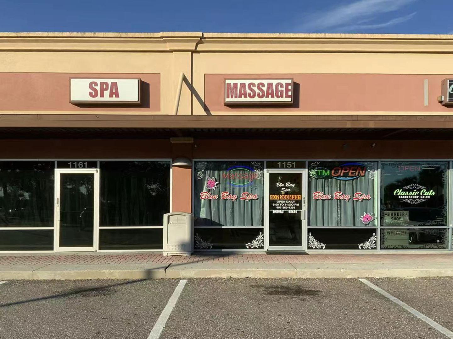 Real storefront of Blue Bay SPA at 1555 State Road 436 Ste 1151 in Winter Park FL — MASSAGE and SPA signs, open daily
